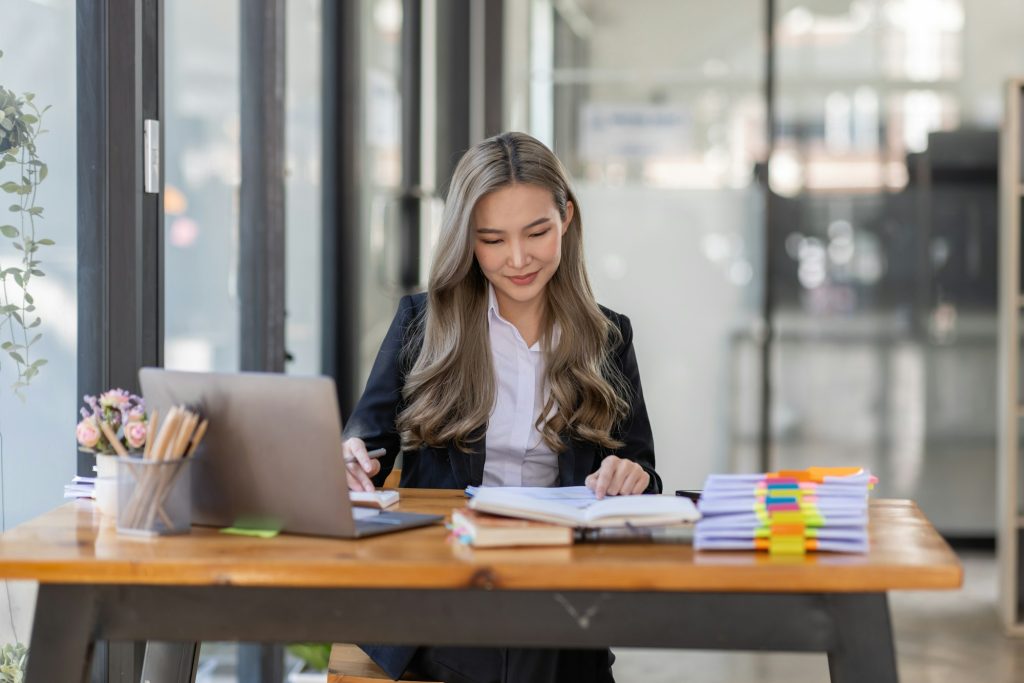 business Asian woman or accountant Bookkeeper working on calculator to calculate business data,